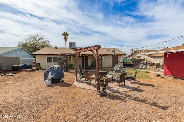 back of property featuring a fire pit, fence, a patio area, a pergola, and stucco siding