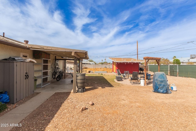 view of yard with an outbuilding and fence