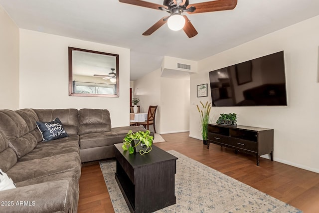 living room with a ceiling fan, wood finished floors, visible vents, and baseboards