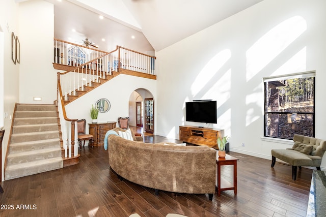 living room with dark hardwood / wood-style floors and high vaulted ceiling