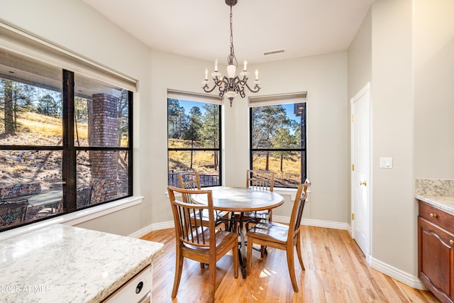 dining room featuring a chandelier and light wood-type flooring