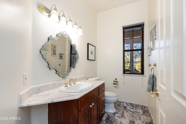 bathroom with vanity and toilet