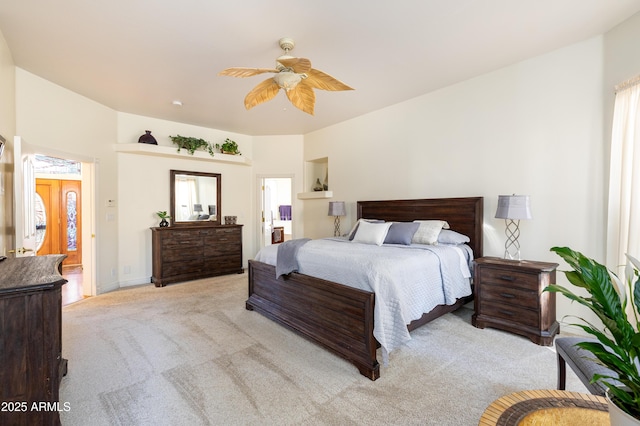 carpeted bedroom with multiple windows and ceiling fan