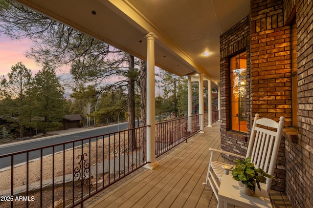 deck at dusk with covered porch