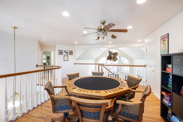 dining room with vaulted ceiling, ceiling fan, and light wood-type flooring