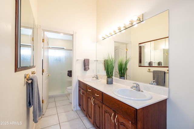 bathroom featuring vanity, tile patterned floors, and toilet