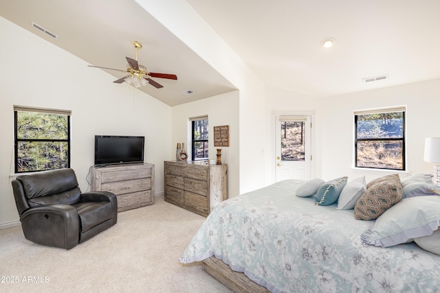 bedroom featuring ceiling fan, vaulted ceiling, and light carpet