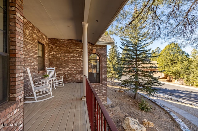 wooden terrace featuring covered porch