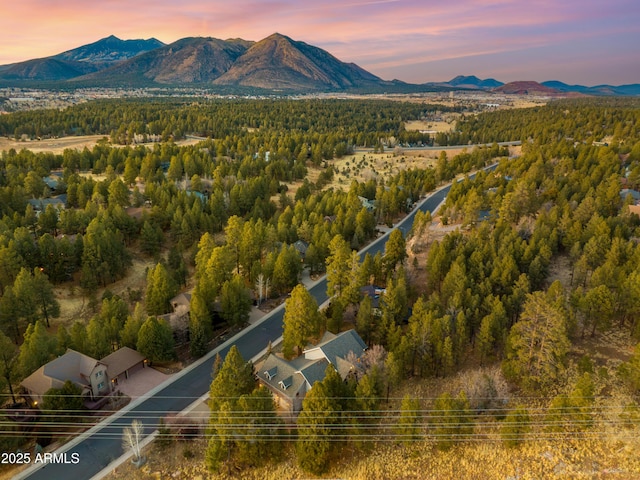 aerial view at dusk featuring a mountain view