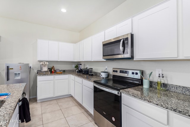 kitchen featuring white cabinets, light tile patterned floors, and stainless steel appliances