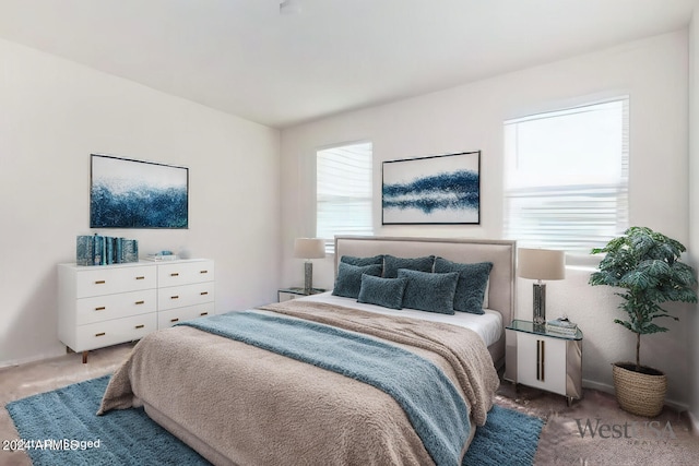 carpeted bedroom featuring multiple windows