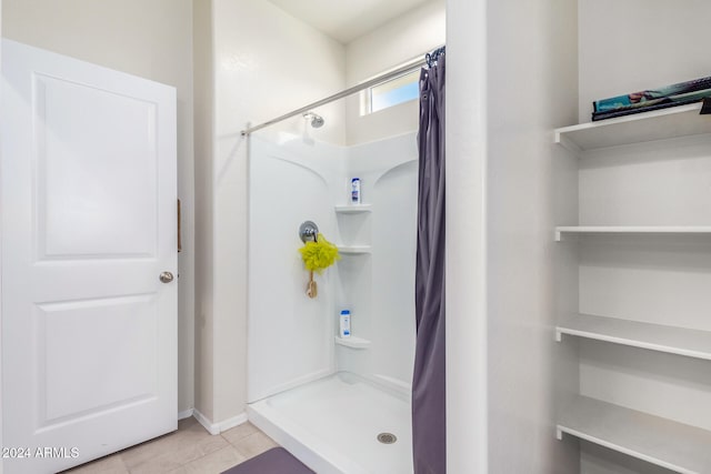 bathroom featuring tile patterned flooring and walk in shower