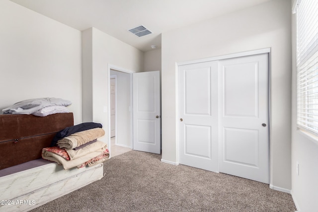 carpeted bedroom featuring a closet