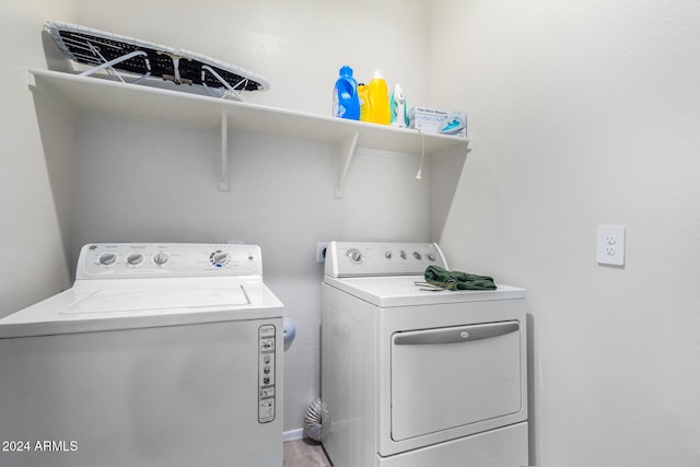 washroom featuring hardwood / wood-style floors and washing machine and clothes dryer