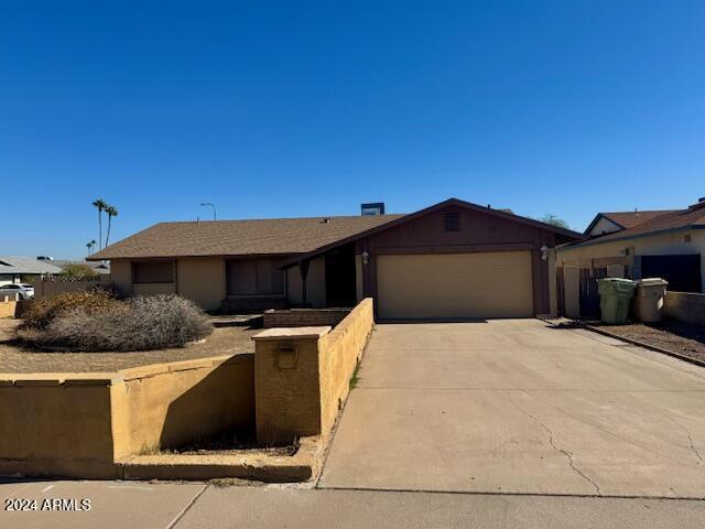 ranch-style house featuring a garage