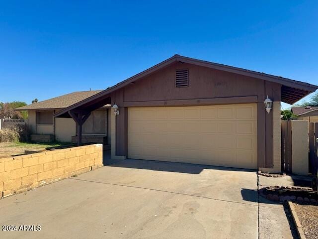 ranch-style home featuring a garage