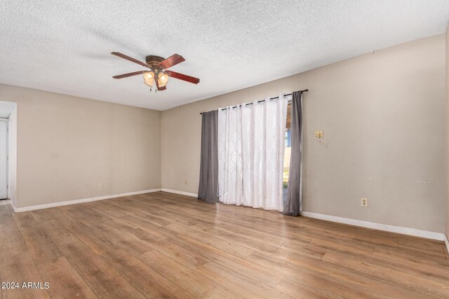 unfurnished room with ceiling fan, light hardwood / wood-style floors, and a textured ceiling