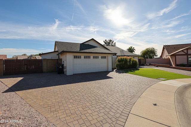 view of front facade featuring a garage and a front lawn