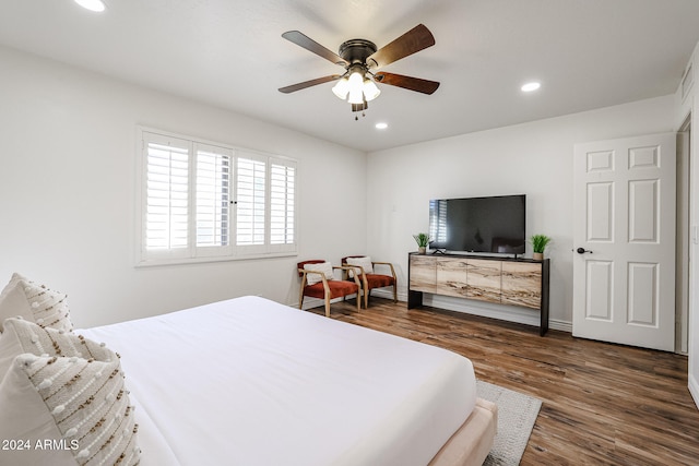 bedroom featuring ceiling fan and dark hardwood / wood-style floors