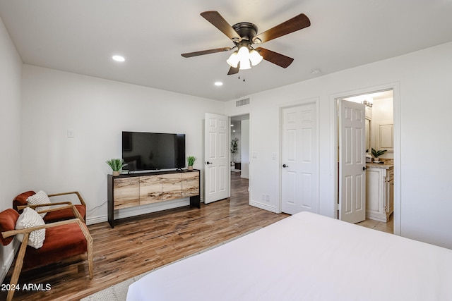 bedroom featuring ensuite bath, ceiling fan, and hardwood / wood-style floors