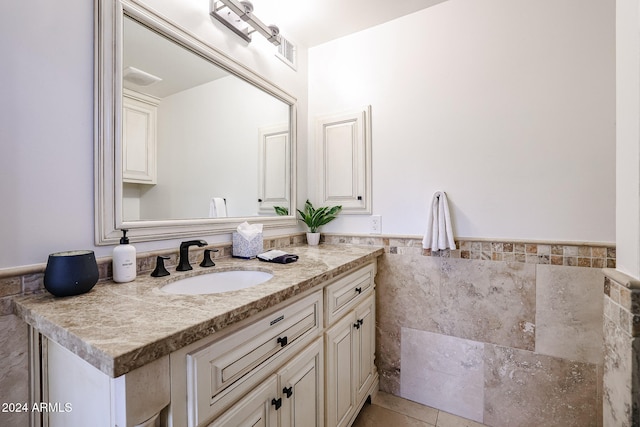 bathroom with vanity, tile patterned floors, and tile walls