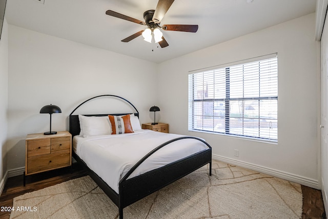 bedroom featuring ceiling fan, a closet, and hardwood / wood-style flooring