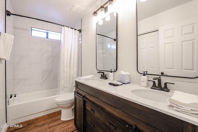 full bathroom with hardwood / wood-style flooring, vanity, toilet, and shower / bathtub combination with curtain