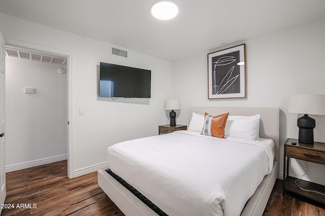 bedroom with dark wood-type flooring