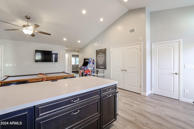 kitchen featuring light wood-type flooring, high vaulted ceiling, and ceiling fan