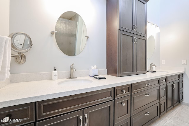 bathroom featuring tile patterned flooring and vanity