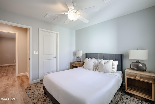 bedroom with ceiling fan and light hardwood / wood-style floors