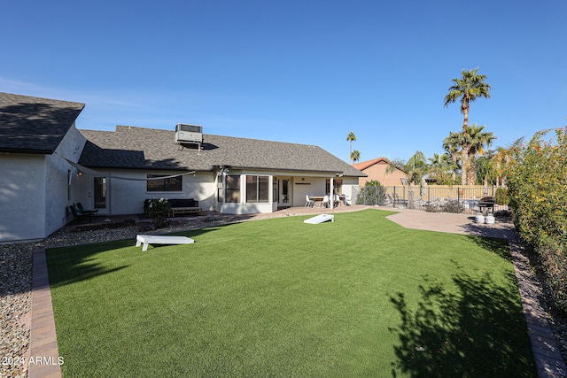 exterior space with cooling unit, a patio area, and a yard