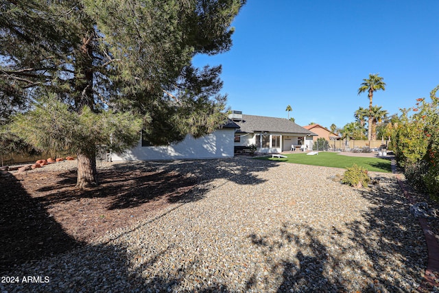 rear view of property with a yard