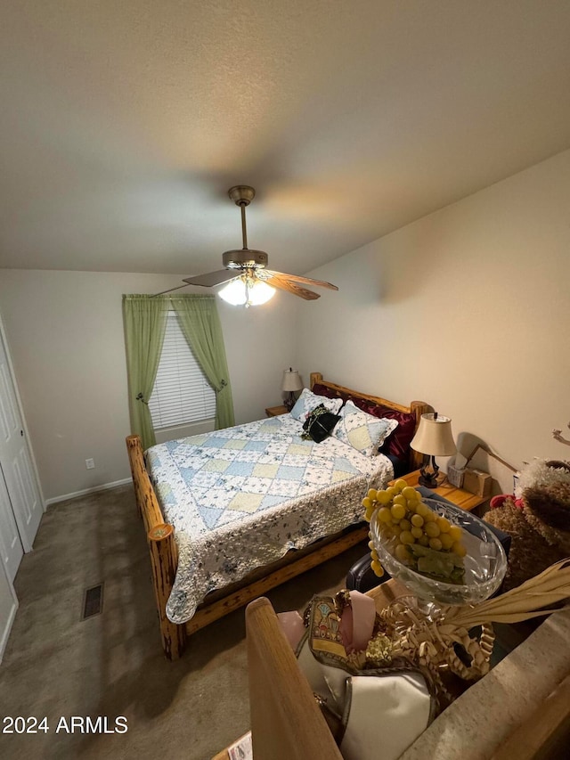 carpeted bedroom with ceiling fan and lofted ceiling