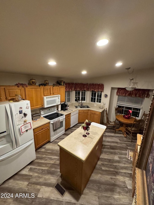 kitchen featuring white appliances, lofted ceiling, sink, dark hardwood / wood-style floors, and a kitchen island