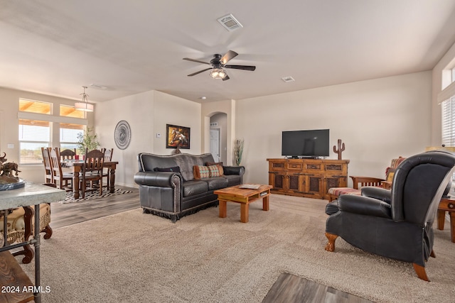 living room featuring ceiling fan and light wood-type flooring