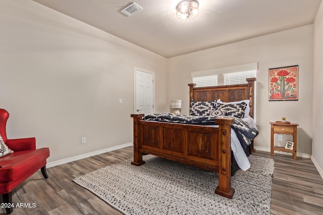 bedroom with dark wood-type flooring