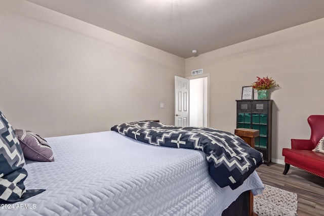 bedroom with wood-type flooring