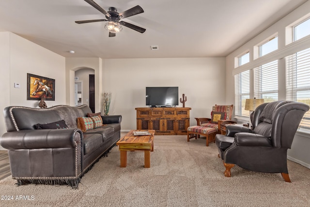 living room with ceiling fan, light colored carpet, and a wealth of natural light