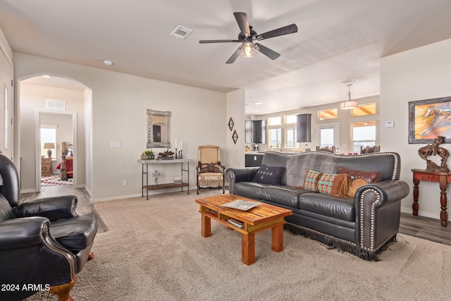 living room with ceiling fan and light hardwood / wood-style flooring