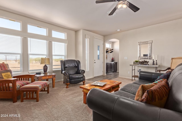 living room with light carpet and ceiling fan