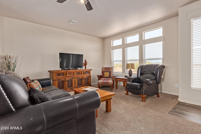 living room with carpet flooring, a wealth of natural light, and ceiling fan