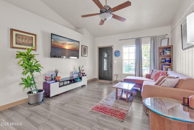 living room with ceiling fan, light hardwood / wood-style flooring, and lofted ceiling