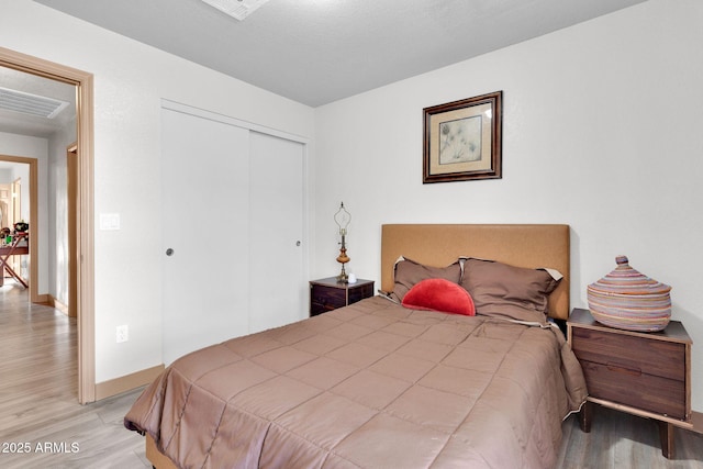 bedroom featuring a closet and light hardwood / wood-style floors