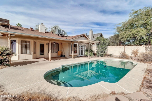 view of swimming pool with ceiling fan and a patio area