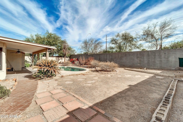 view of yard featuring a fenced in pool, ceiling fan, and a patio