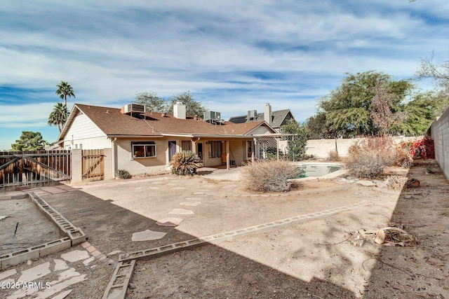 rear view of house featuring a patio and central AC