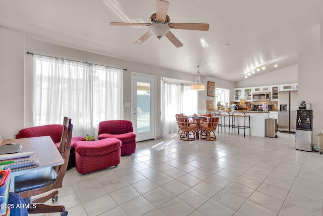 tiled living room featuring a wealth of natural light, lofted ceiling, and ceiling fan