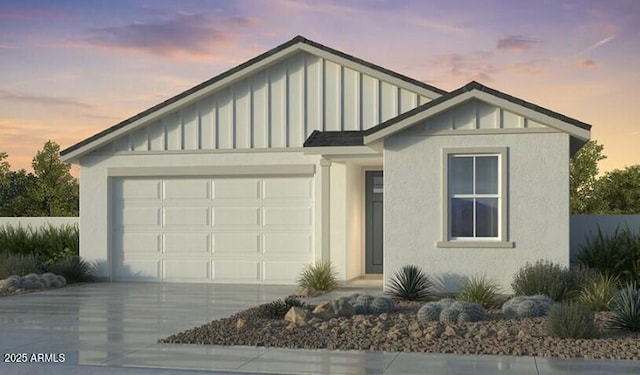 view of front of house featuring an attached garage, stucco siding, board and batten siding, and concrete driveway