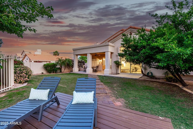 view of yard with ceiling fan and a patio
